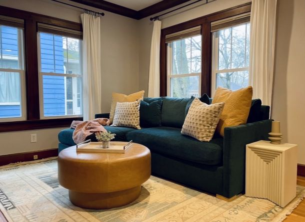 A cozy living room featuring a blue couch adorned with yellow pillows, creating a vibrant and inviting atmosphere.
