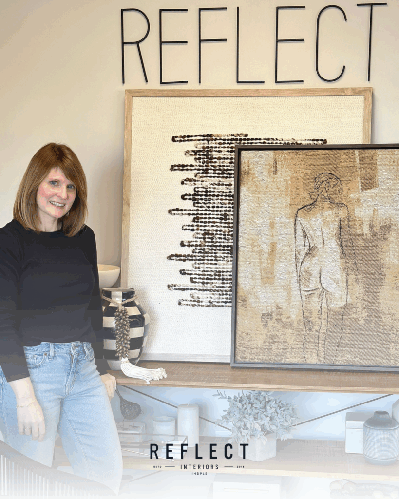 A woman poses in front of a large painting, showcasing her appreciation for the artwork's scale, design and creativity.